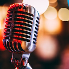 A vintage microphone under warm stage lights