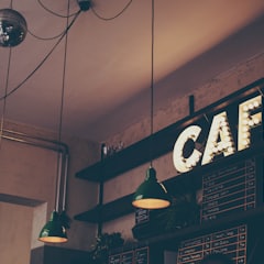 A lit café sign above the counter