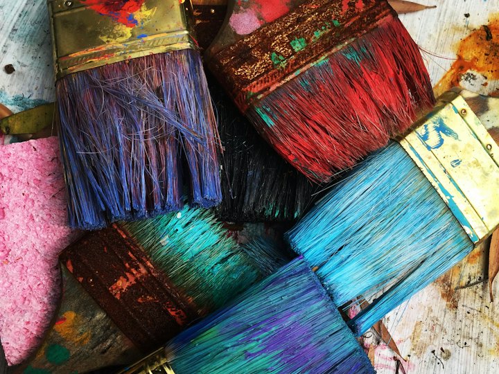 Paintbrushes loaded with bright paint